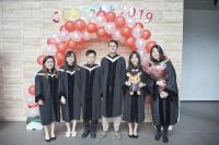 Students in the graduating class of 2019 taking photos in front of the balloon arch made by the Residents' Association